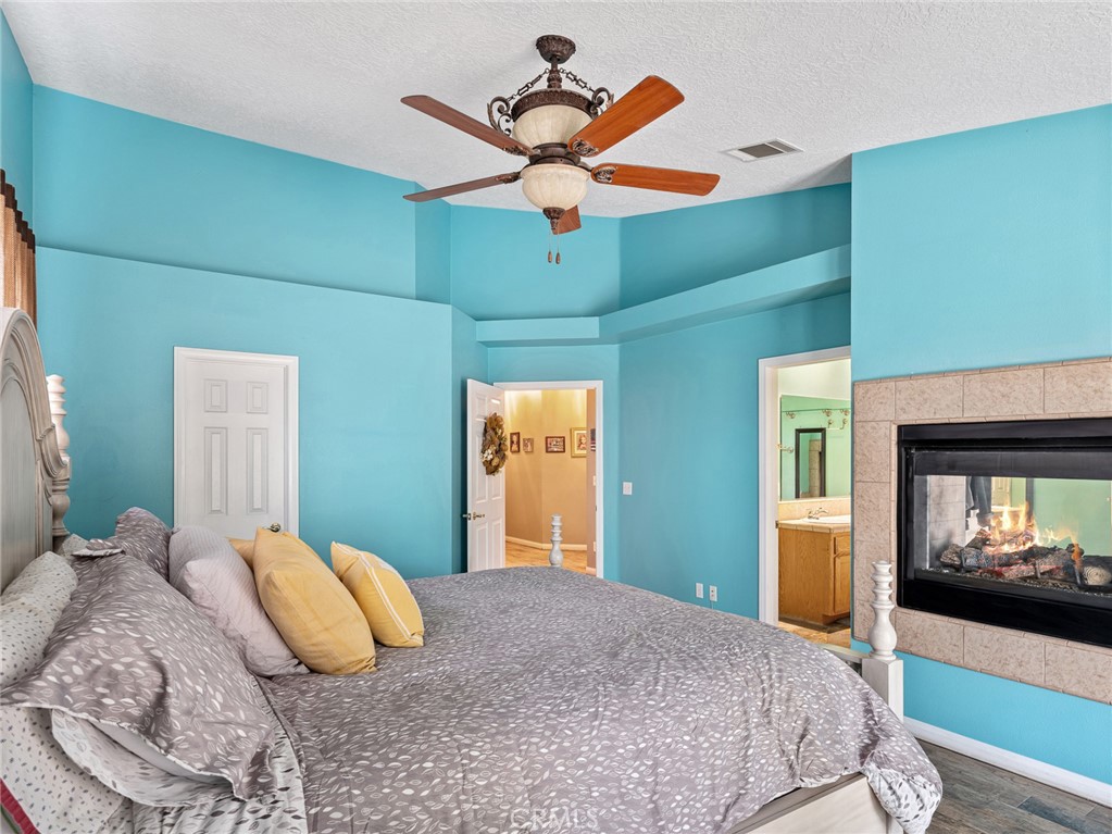 10160 Pineview Road Pinon Hills, CA 92372 - Photo 25 of 46 a bedroom with a bed and a chandelier