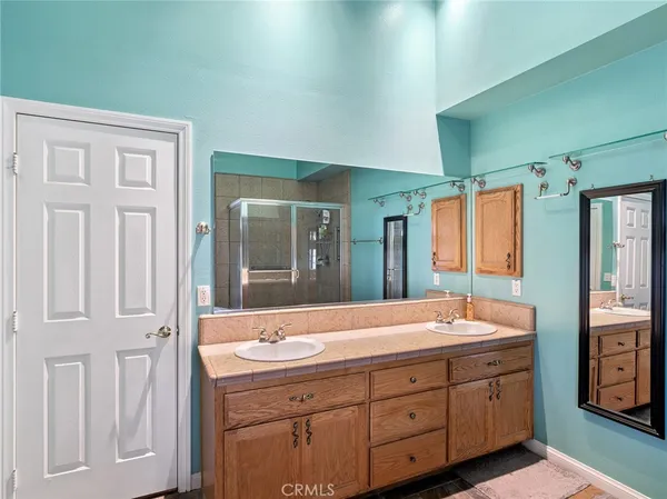 a bathroom with a granite countertop sink and a large mirror