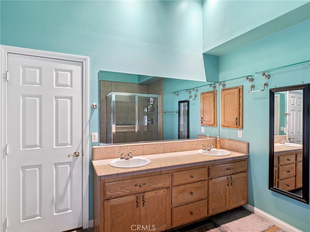 10160 Pineview Road Pinon Hills, CA 92372 - Photo 27 of 46 a bathroom with a granite countertop sink and a large mirror
