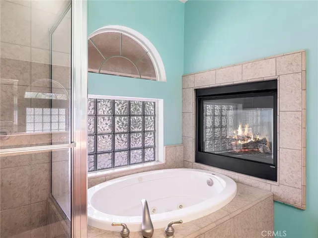 a bathroom with a tub and a large window