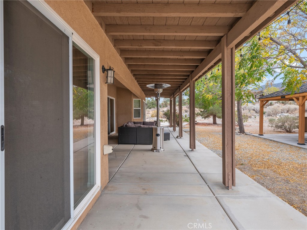10160 Pineview Road Pinon Hills, CA 92372 - Photo 29 of 46 a view of living room kitchen with furniture and floor to ceiling window