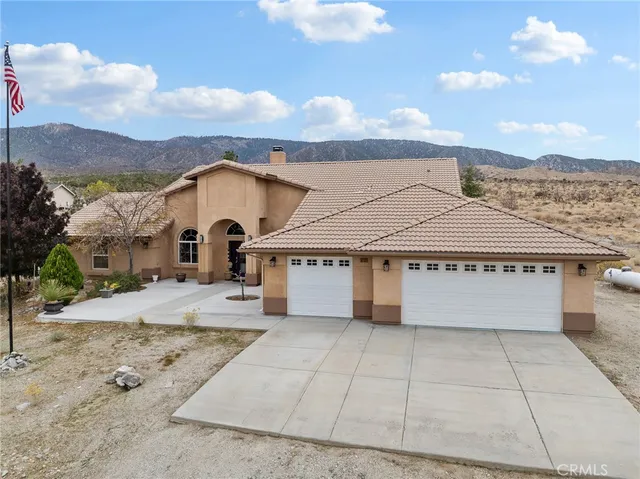a view of a white house with a yard