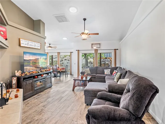 a living room with furniture ceiling fan and a rug