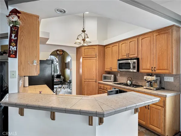 a kitchen with stainless steel appliances granite countertop a sink refrigerator and microwave