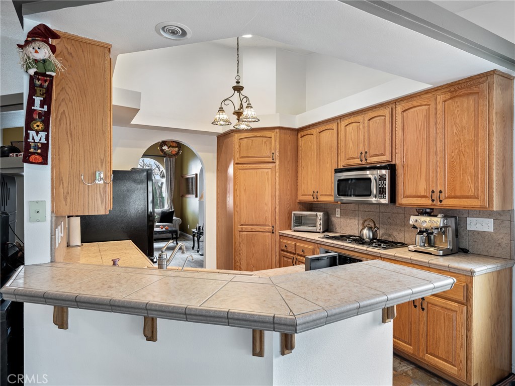 10160 Pineview Road Pinon Hills, CA 92372 - Photo 10 of 46 a kitchen with stainless steel appliances granite countertop a sink refrigerator and microwave