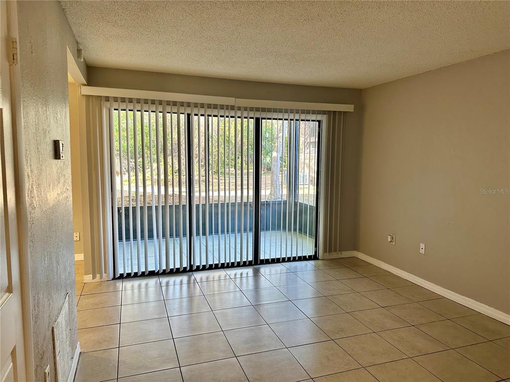 5801 Windhover Drive, Unit A01 Orlando, FL 32819 - Photo 2 of 14 a view of an empty room and window