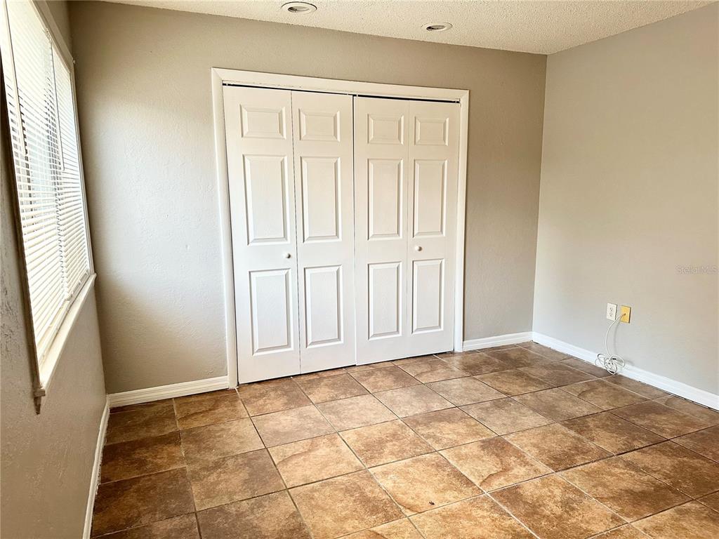 5801 Windhover Drive, Unit A01 Orlando, FL 32819 - Photo 7 of 14 an empty room with window