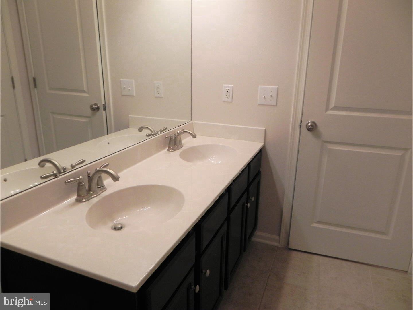 3880 Cephas Child Road, Unit 9 Doylestown, PA 18902 - Photo 11 of 18 a bathroom with a sink and a mirror