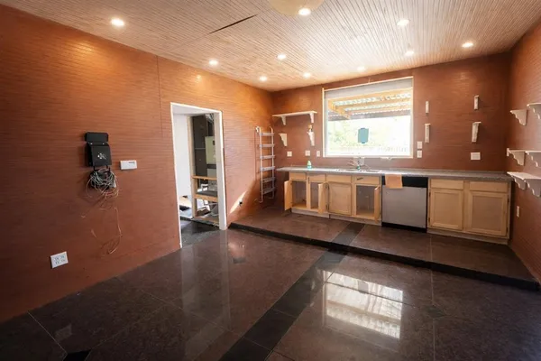 a view of a house with a yard and wooden fence