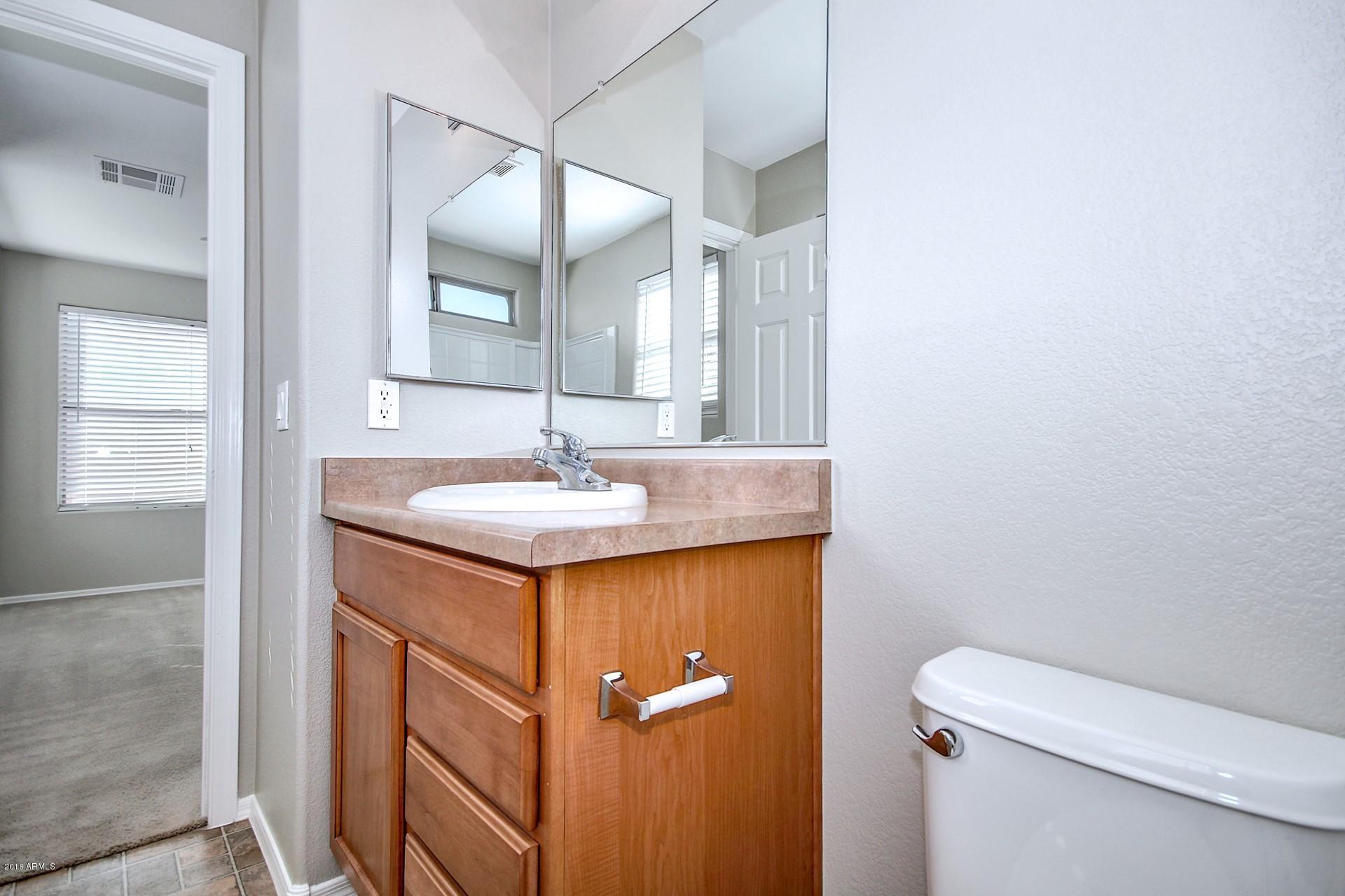 6416 West Beverly Road Laveen, AZ 85339 - Photo 14 of 22 a bathroom with a sink toilet and vanity