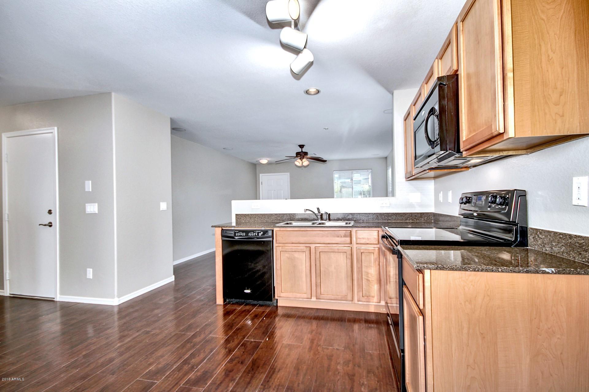 6416 West Beverly Road Laveen, AZ 85339 - Photo 4 of 22 a kitchen with stainless steel appliances granite countertop a stove and a sink
