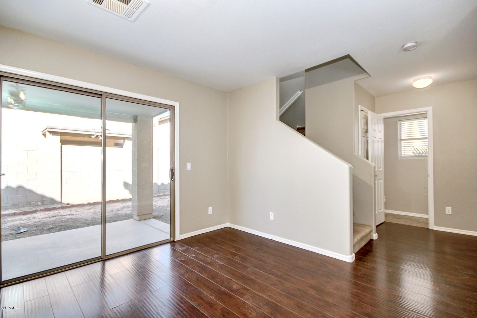6416 West Beverly Road Laveen, AZ 85339 - Photo 5 of 22 wooden floor in an empty room with a window