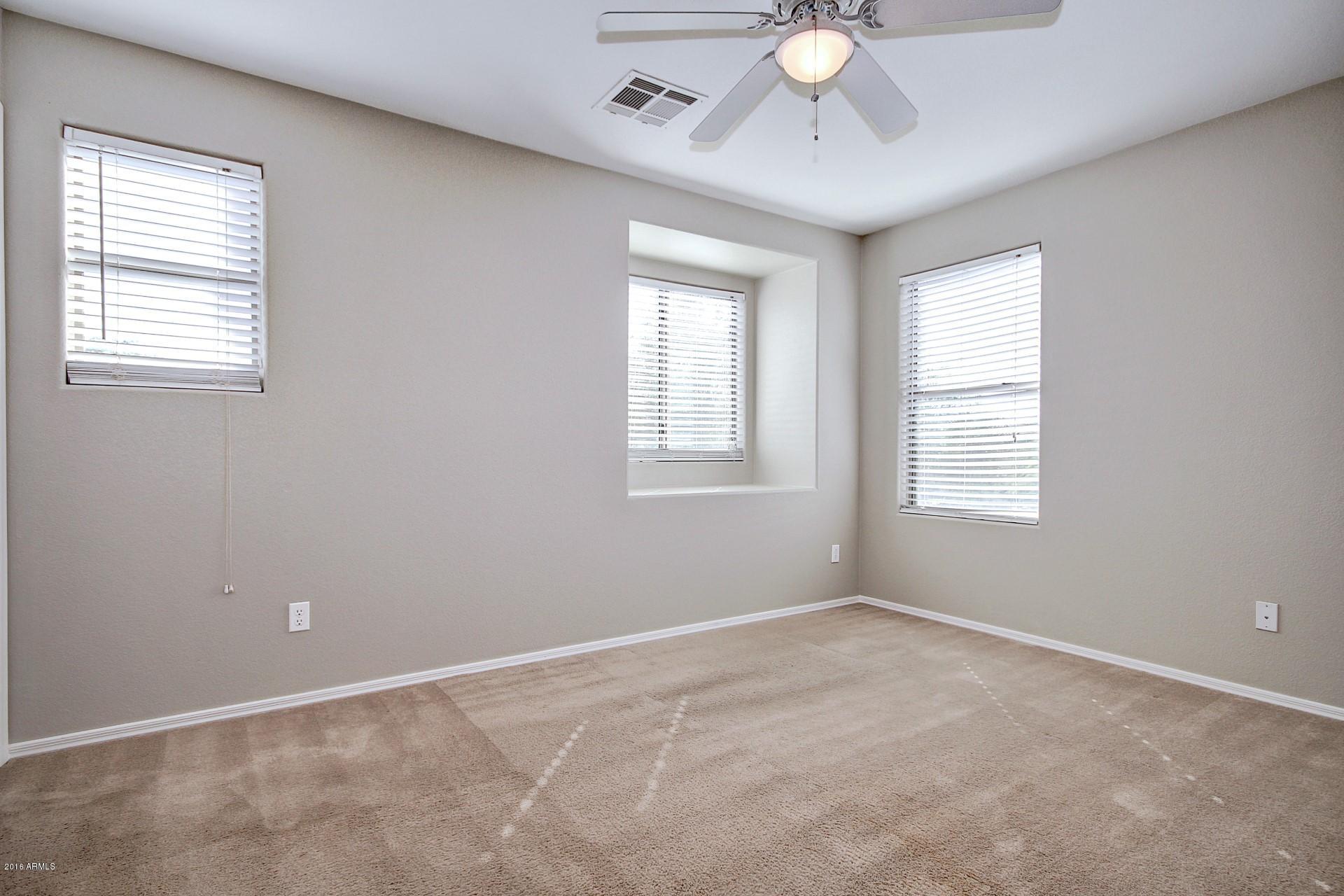6416 West Beverly Road Laveen, AZ 85339 - Photo 10 of 22 a view of an empty room with a window