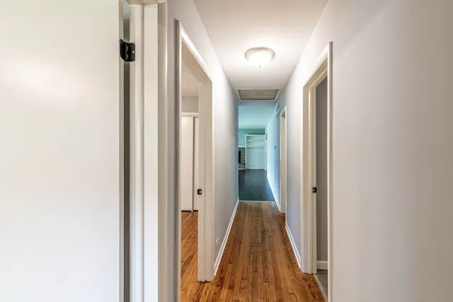 a view of a hallway with a door and stairs