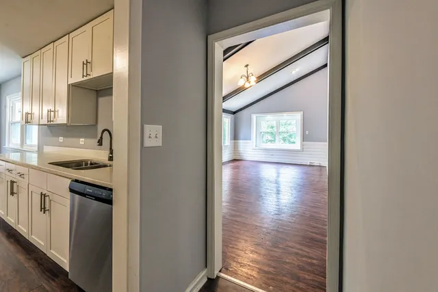 a kitchen with stainless steel appliances granite countertop a stove a sink and a refrigerator with wooden floor