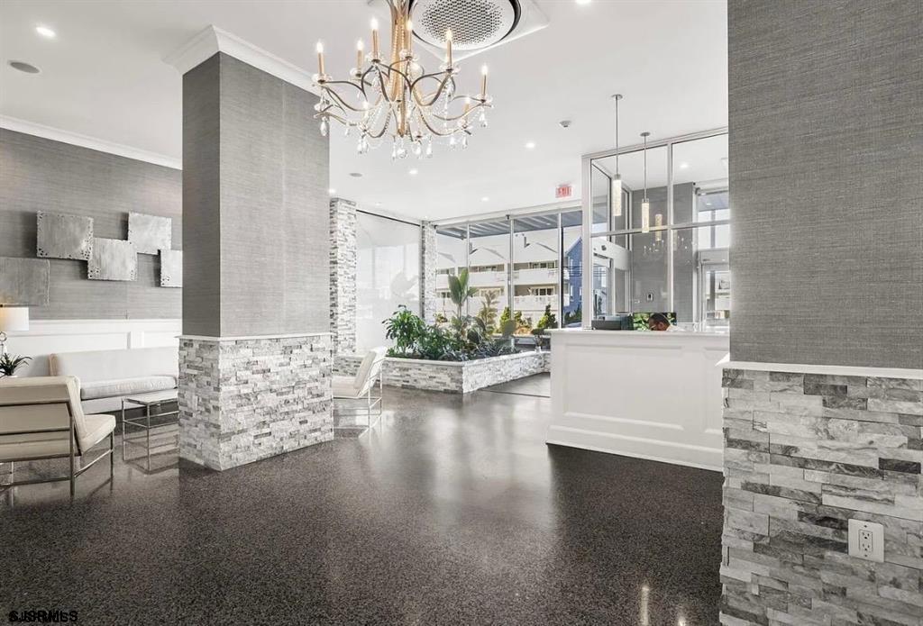 9400 Atlantic Avenue, Unit 306 Margate City, NJ 08402 - Photo 13 of 17 a view of a living room and chandelier