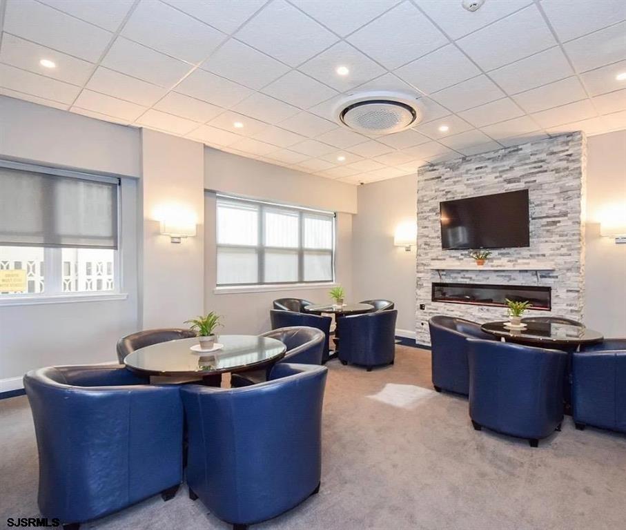 9400 Atlantic Avenue, Unit 306 Margate City, NJ 08402 - Photo 15 of 17 a living room with furniture and a flat screen tv