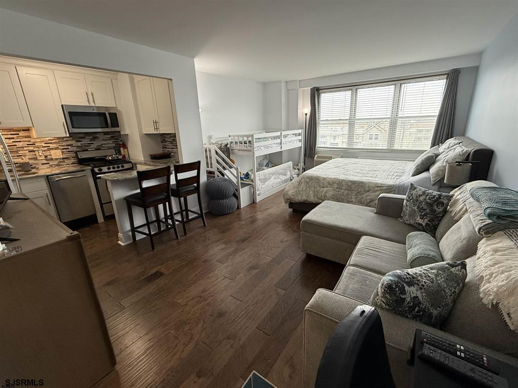 9400 Atlantic Avenue, Unit 306 Margate City, NJ 08402 - Photo 2 of 17 a living room with furniture and a flat screen tv