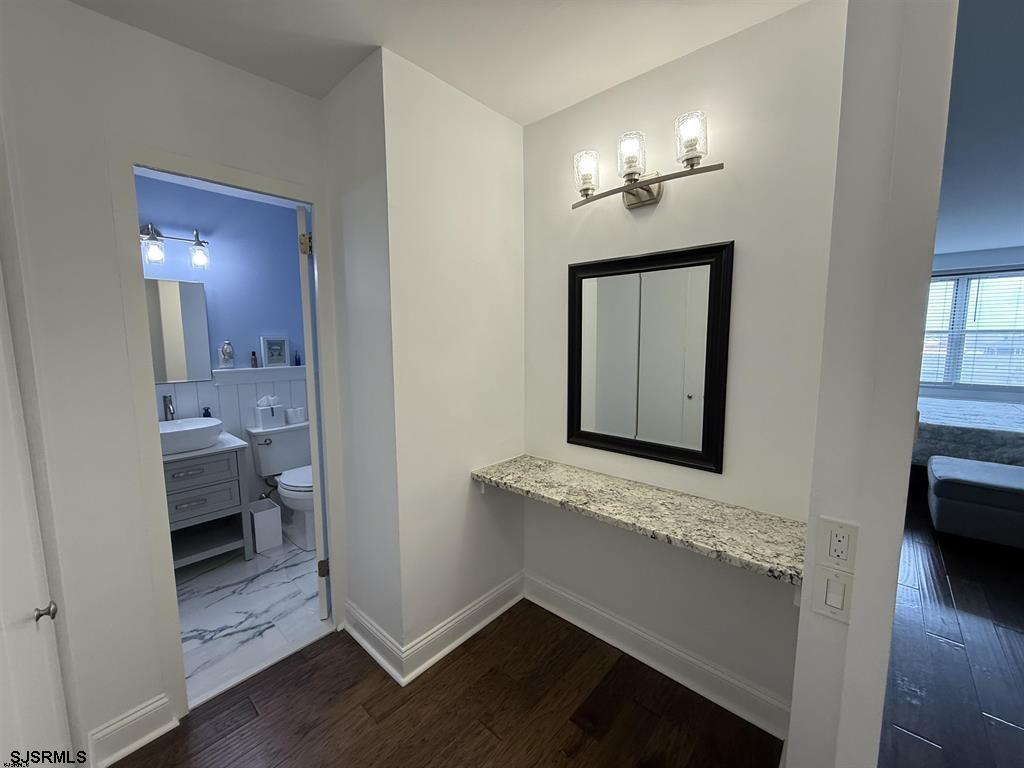9400 Atlantic Avenue, Unit 306 Margate City, NJ 08402 - Photo 6 of 17 a bathroom with a sink a light fixture and a mirror
