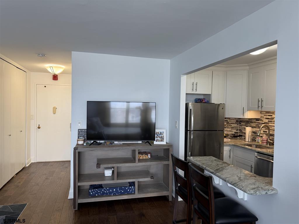 9400 Atlantic Avenue, Unit 306 Margate City, NJ 08402 - Photo 7 of 17 a kitchen with a refrigerator and a stove top open