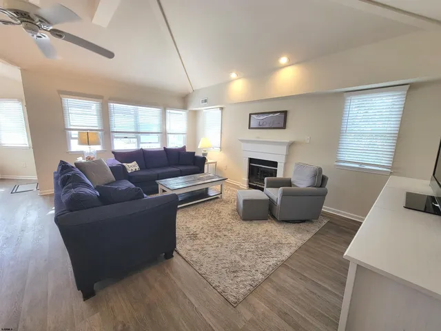 a living room with furniture fireplace and window