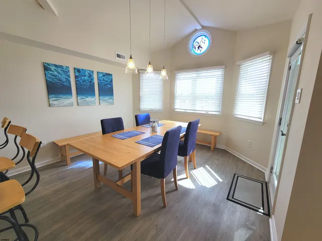 a view of a dining room with furniture and a chandelier