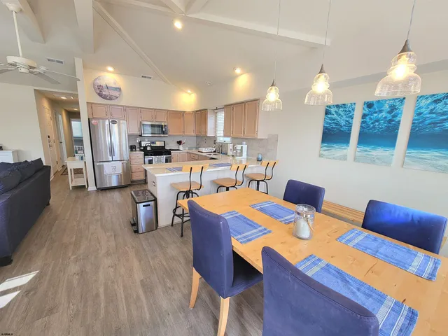 a kitchen with kitchen island a white cabinets and wooden floor