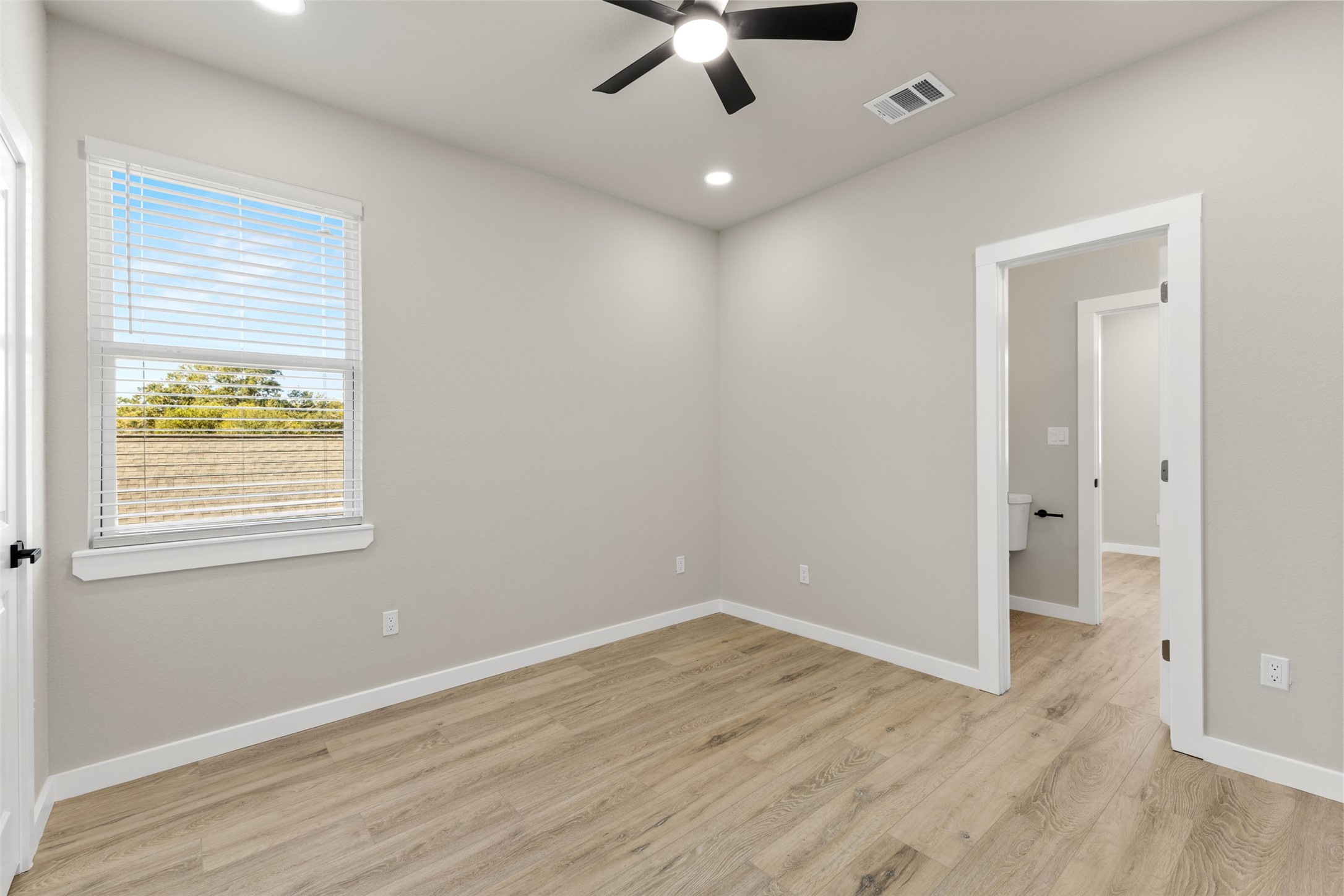 1504 Clay Street, Unit AB Brenham, TX 77833 - Photo 13 of 30 wooden floor in an empty room with a window