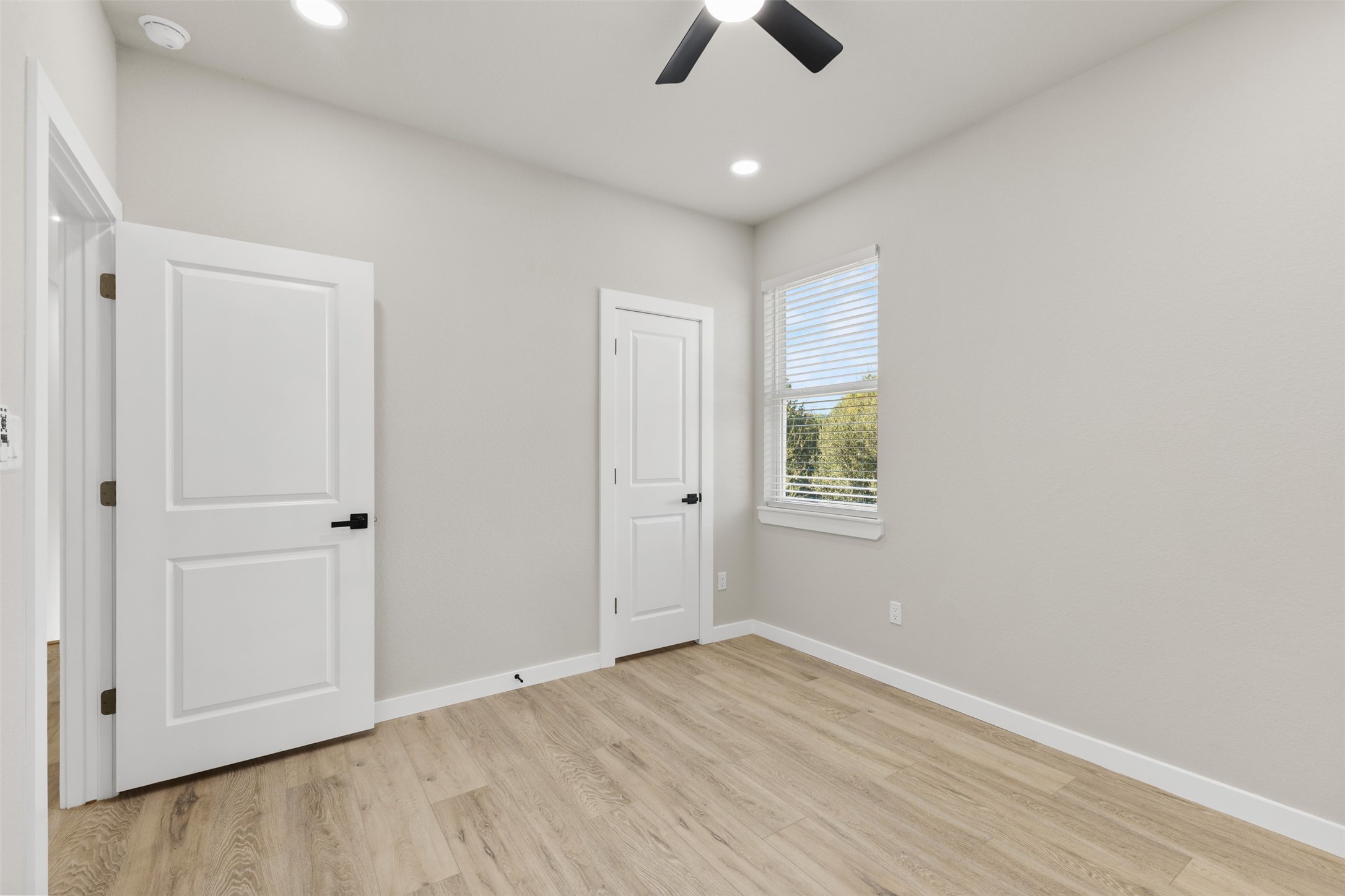 1504 Clay Street, Unit AB Brenham, TX 77833 - Photo 14 of 30 wooden floor in an empty room with a window