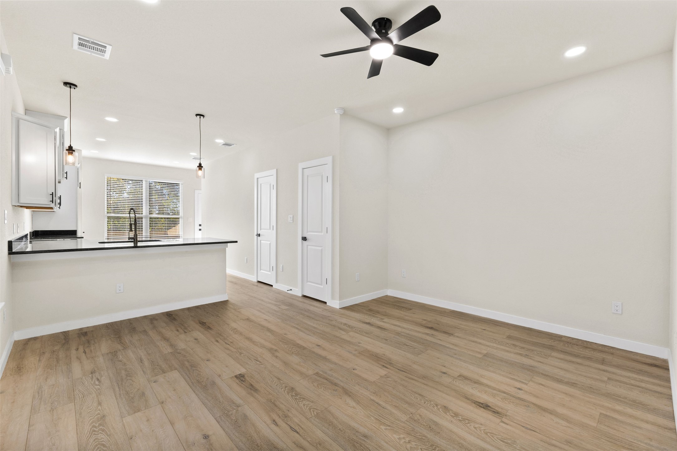 1504 Clay Street, Unit AB Brenham, TX 77833 - Photo 21 of 30 a view of an empty room and kitchen with kitchen island