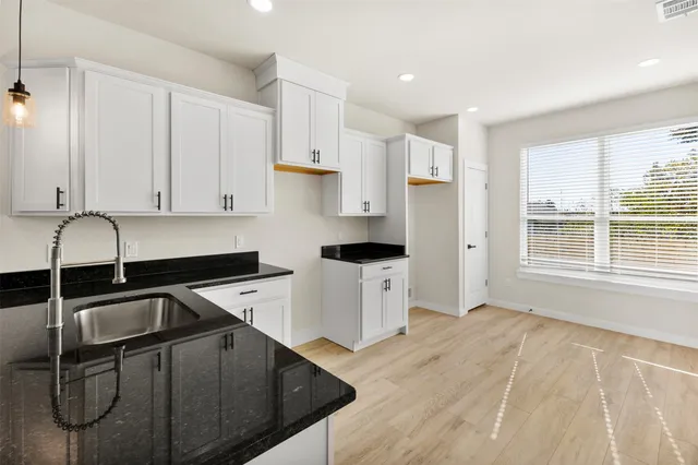 a close view of a sink and a vanity in the kitchen