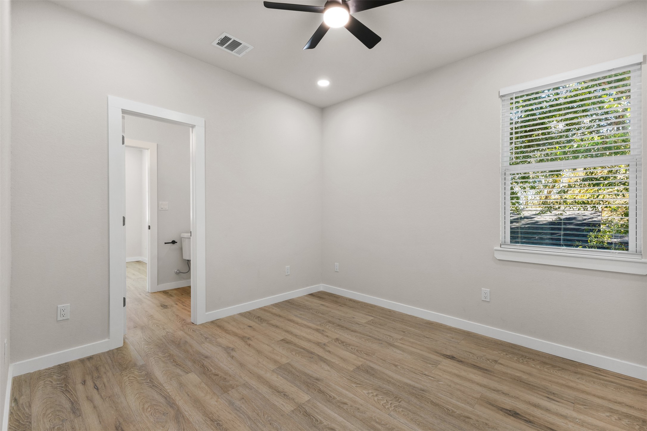 1504 Clay Street, Unit AB Brenham, TX 77833 - Photo 28 of 30 wooden floor in an empty room with a window
