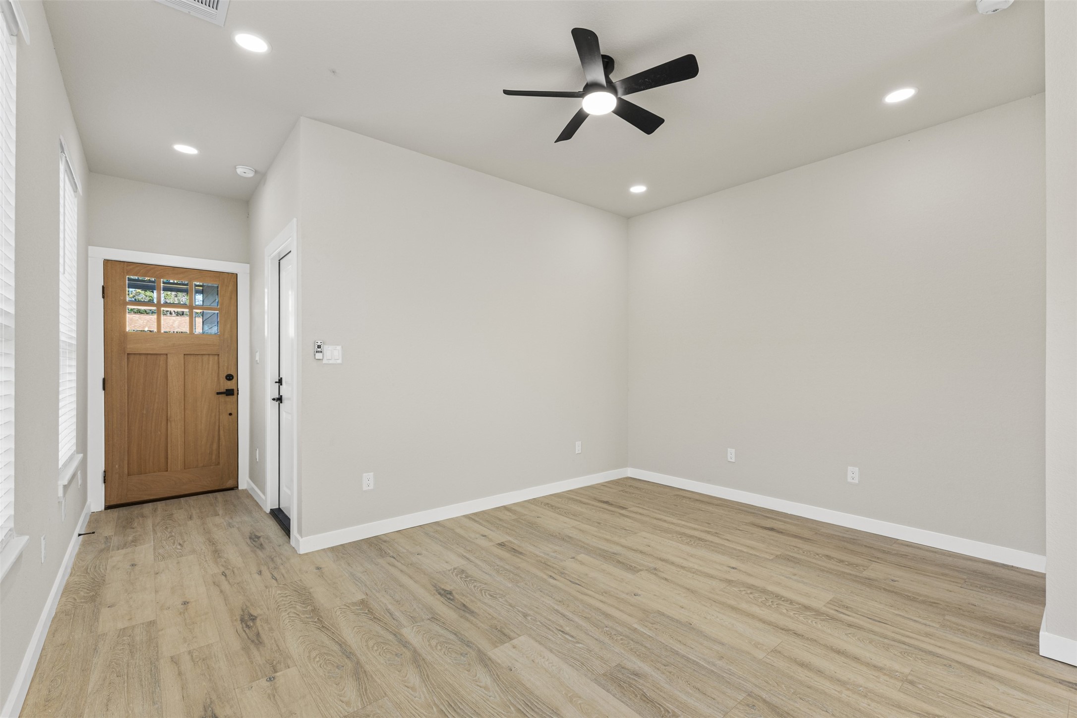 1504 Clay Street, Unit AB Brenham, TX 77833 - Photo 4 of 30 wooden floor in an empty room with a window
