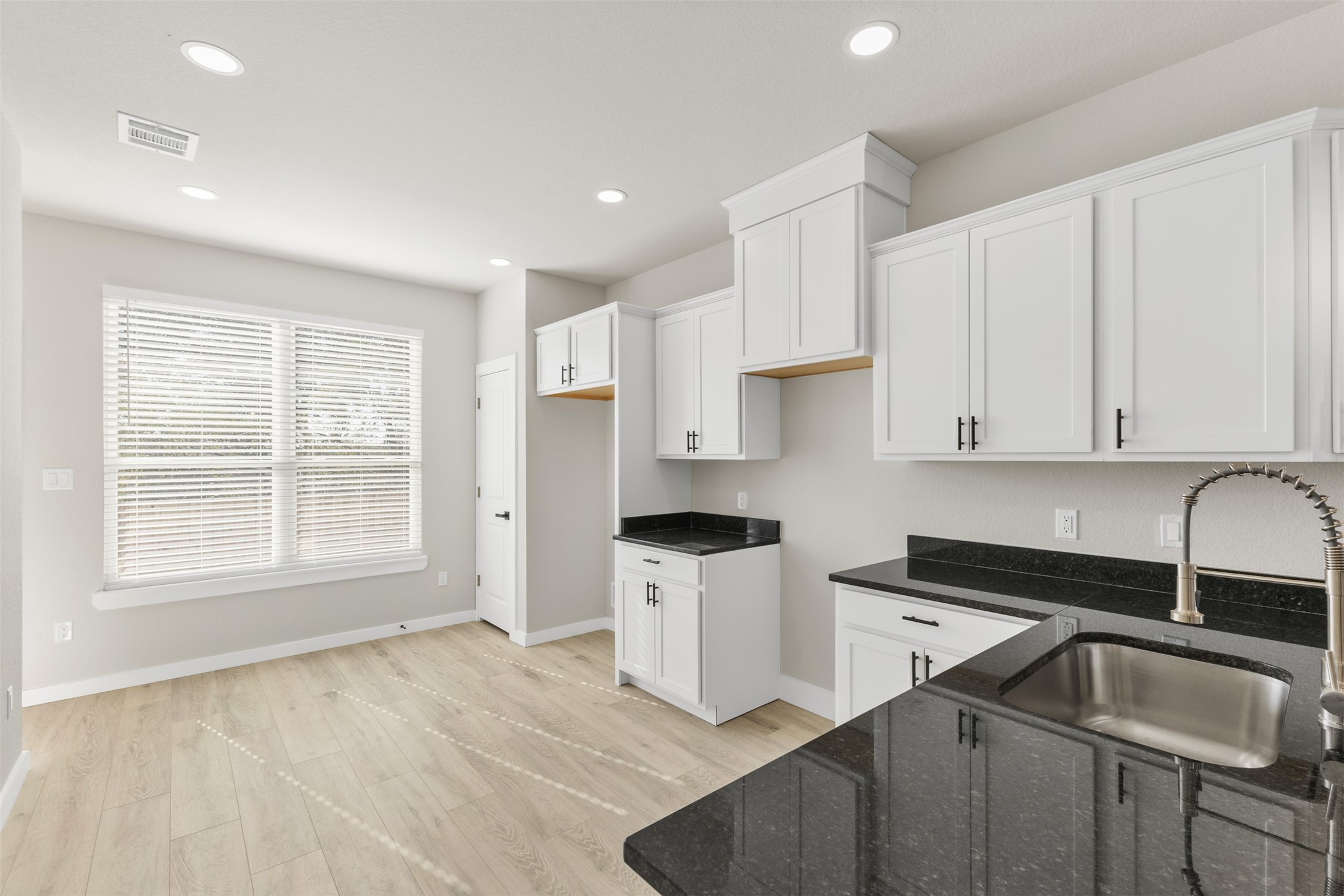 1504 Clay Street, Unit AB Brenham, TX 77833 - Photo 6 of 30 a kitchen that has a sink a stove and cabinets