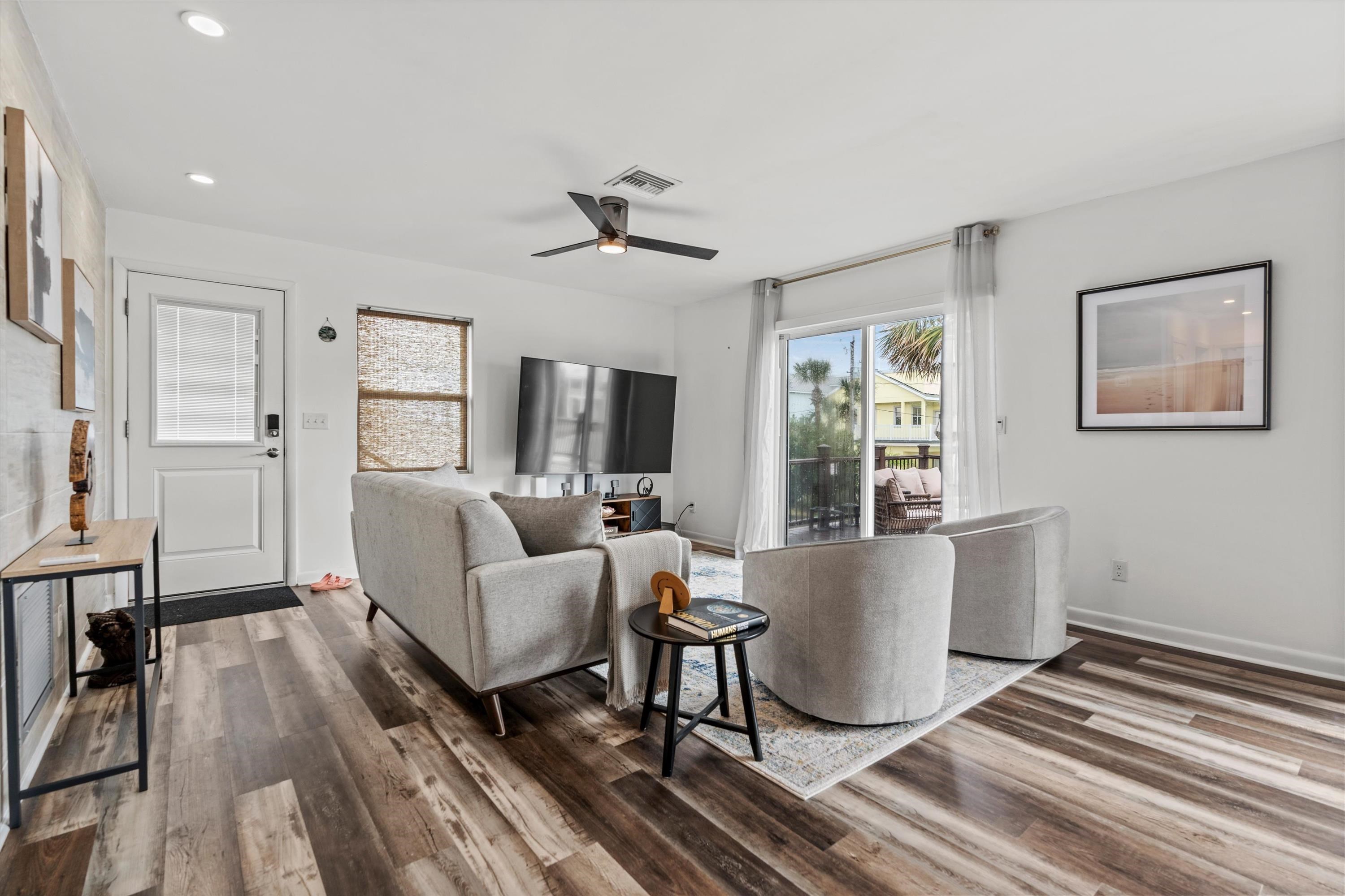 9 3rd Street, Unit UP St. Augustine, FL 32080 - Photo 11 of 24 a living room with furniture a large window wooden floor and a rug
