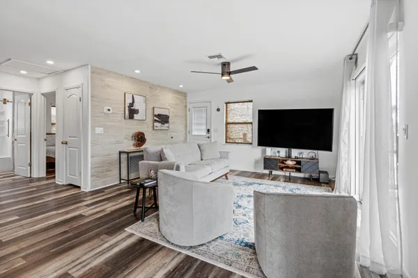 a bedroom with a bed and a refrigerator