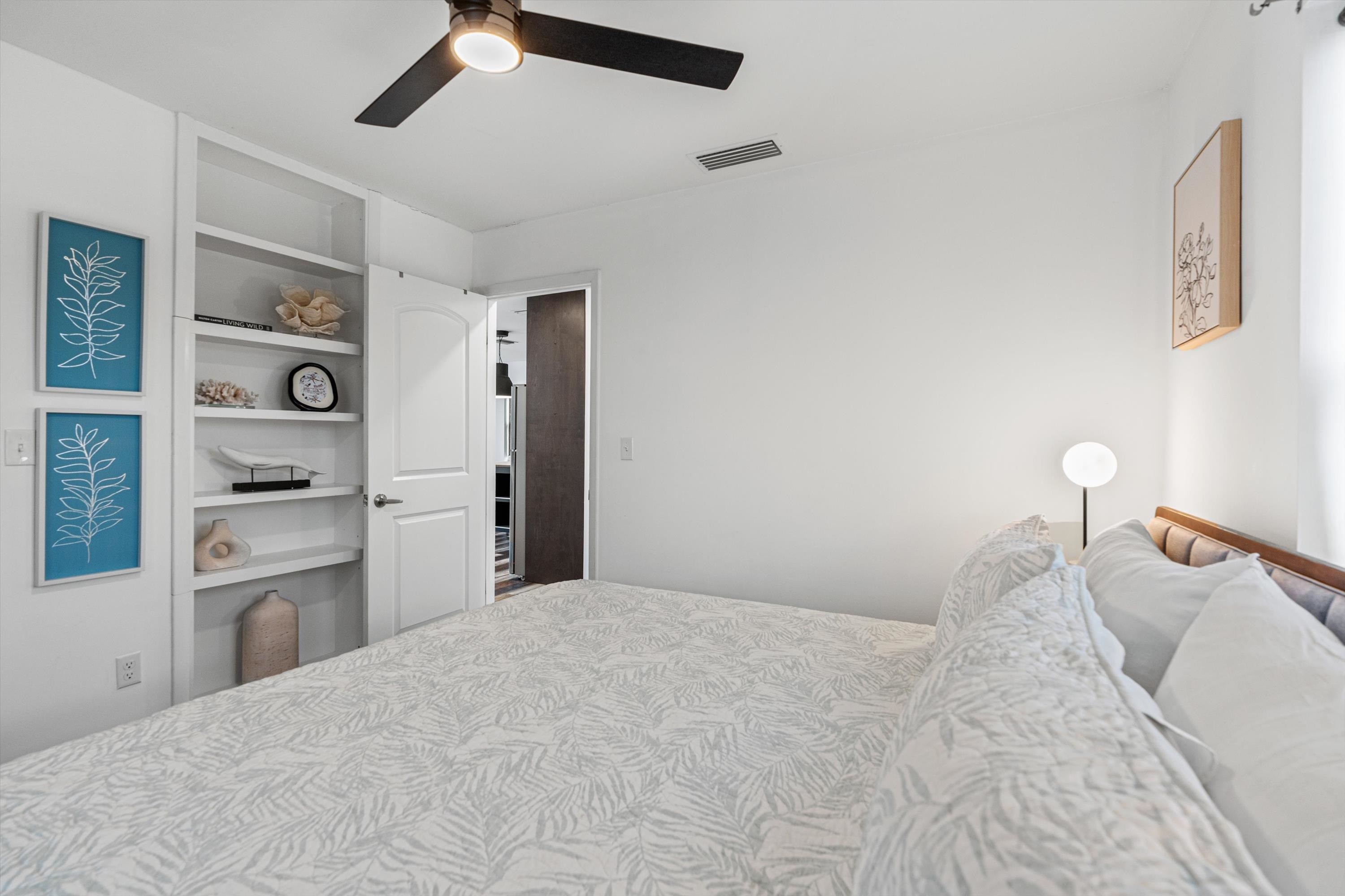 9 3rd Street, Unit UP St. Augustine, FL 32080 - Photo 16 of 24 a bedroom with a bed and cabinets