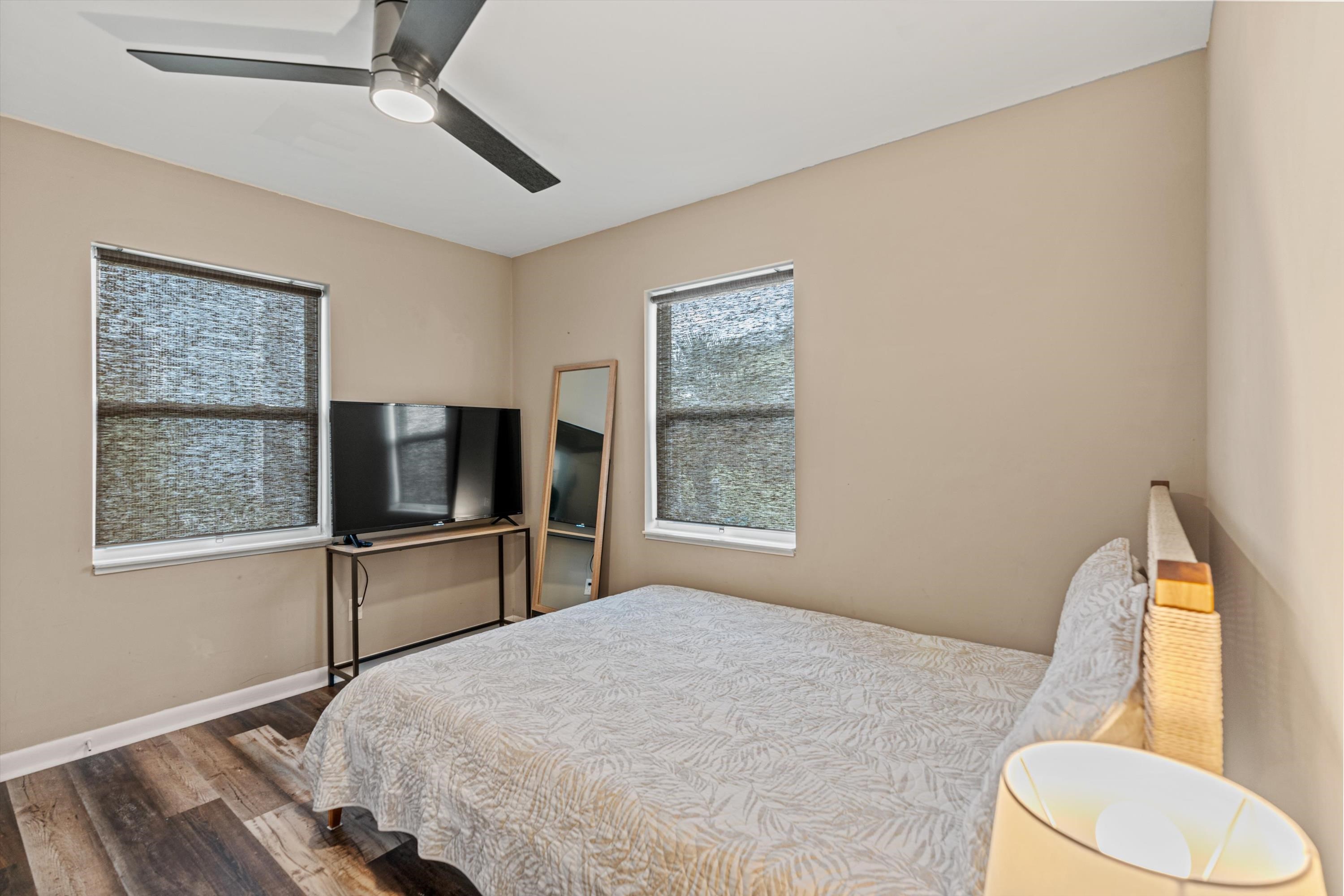 9 3rd Street, Unit UP St. Augustine, FL 32080 - Photo 20 of 24 a bedroom with a bed and a flat tv screen on dresser