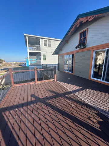 a kitchen with stainless steel appliances granite countertop a table chairs and a refrigerator