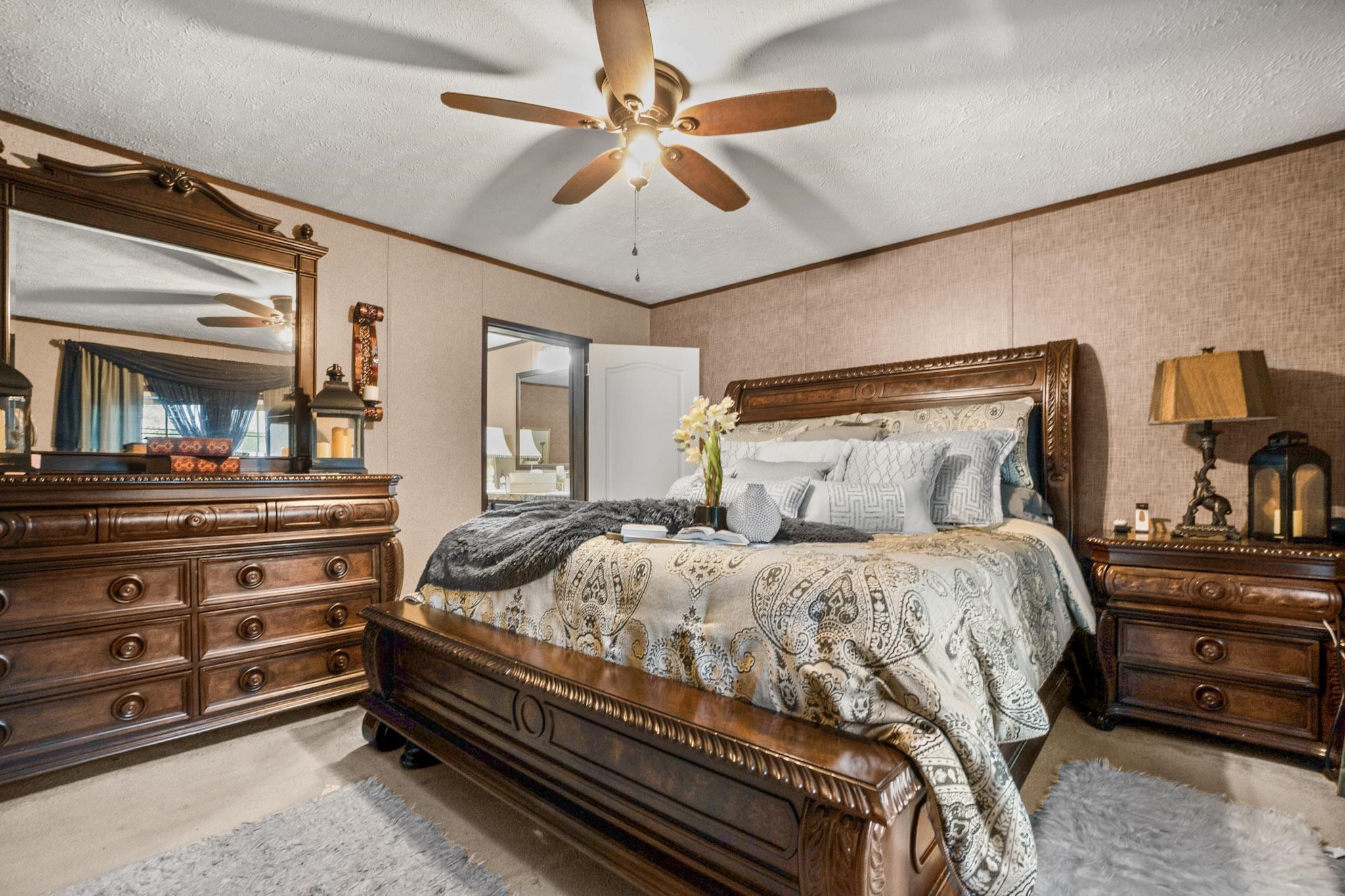 3779 Dancyville Road Stanton, TN 38069 - Photo 12 of 40 a bedroom with a bed and a chandelier