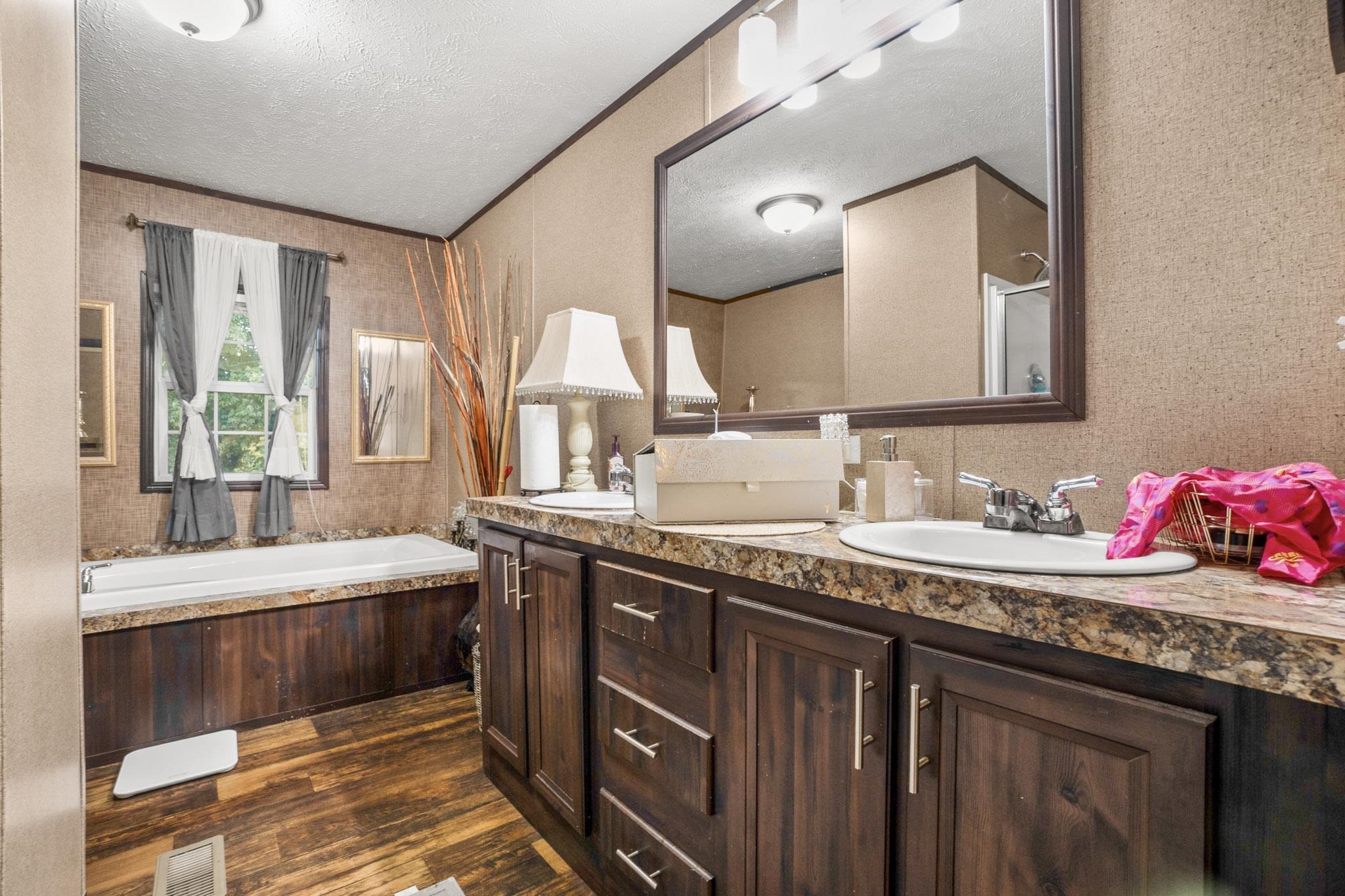 3779 Dancyville Road Stanton, TN 38069 - Photo 13 of 40 a bathroom with a granite countertop double vanity sink and a mirror