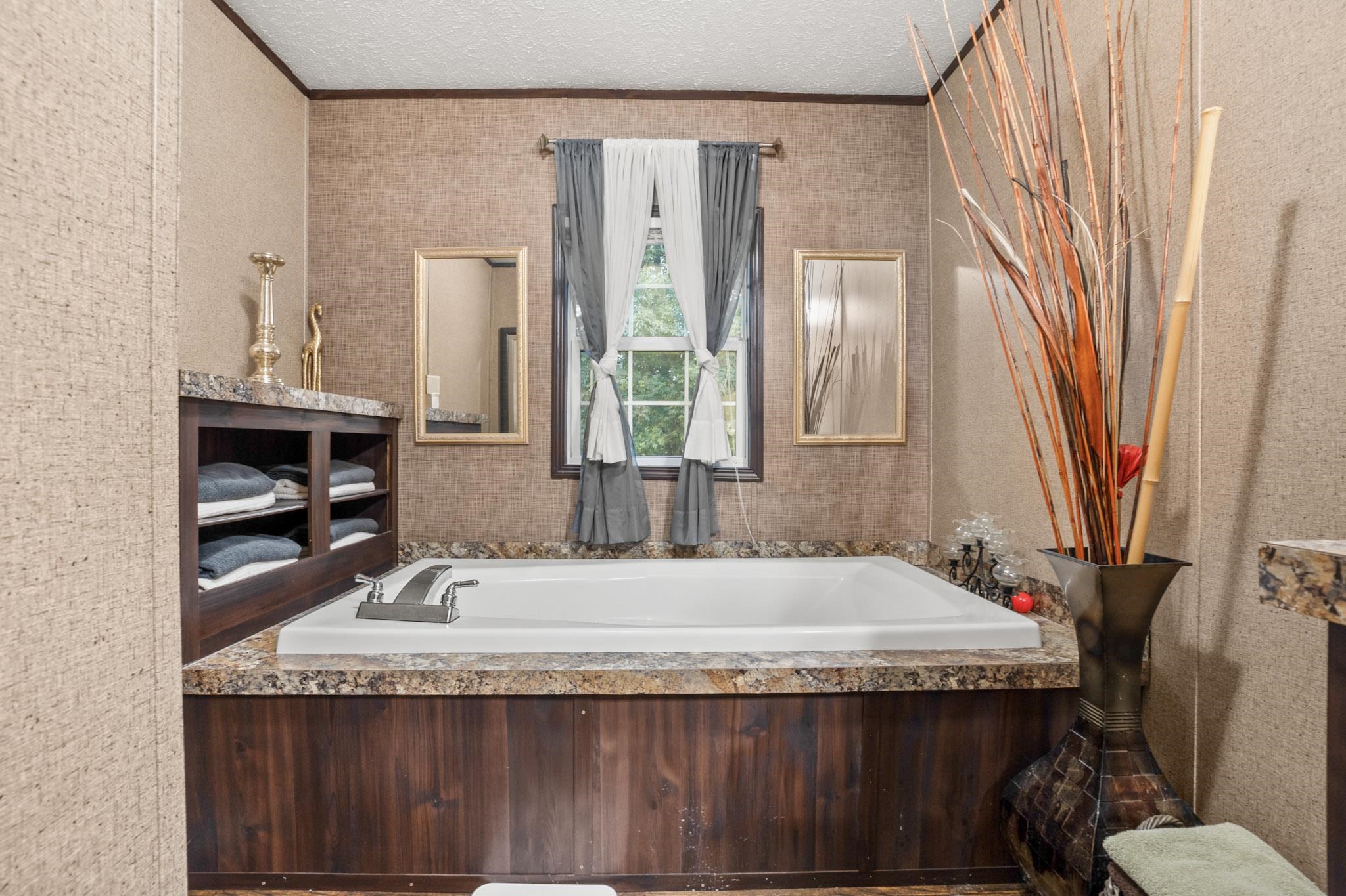 3779 Dancyville Road Stanton, TN 38069 - Photo 14 of 40 a bathroom with a granite countertop sink and a mirror
