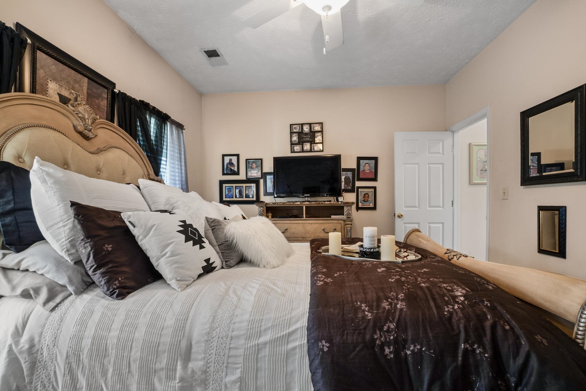 3779 Dancyville Road Stanton, TN 38069 - Photo 17 of 40 a bedroom with a bed and flat screen tv
