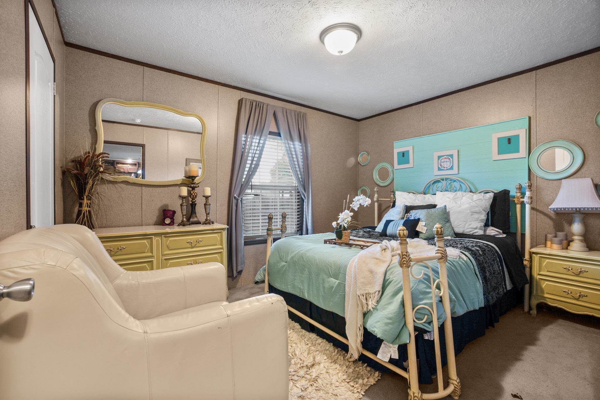 3779 Dancyville Road Stanton, TN 38069 - Photo 18 of 40 a bedroom with a bed and a chandelier