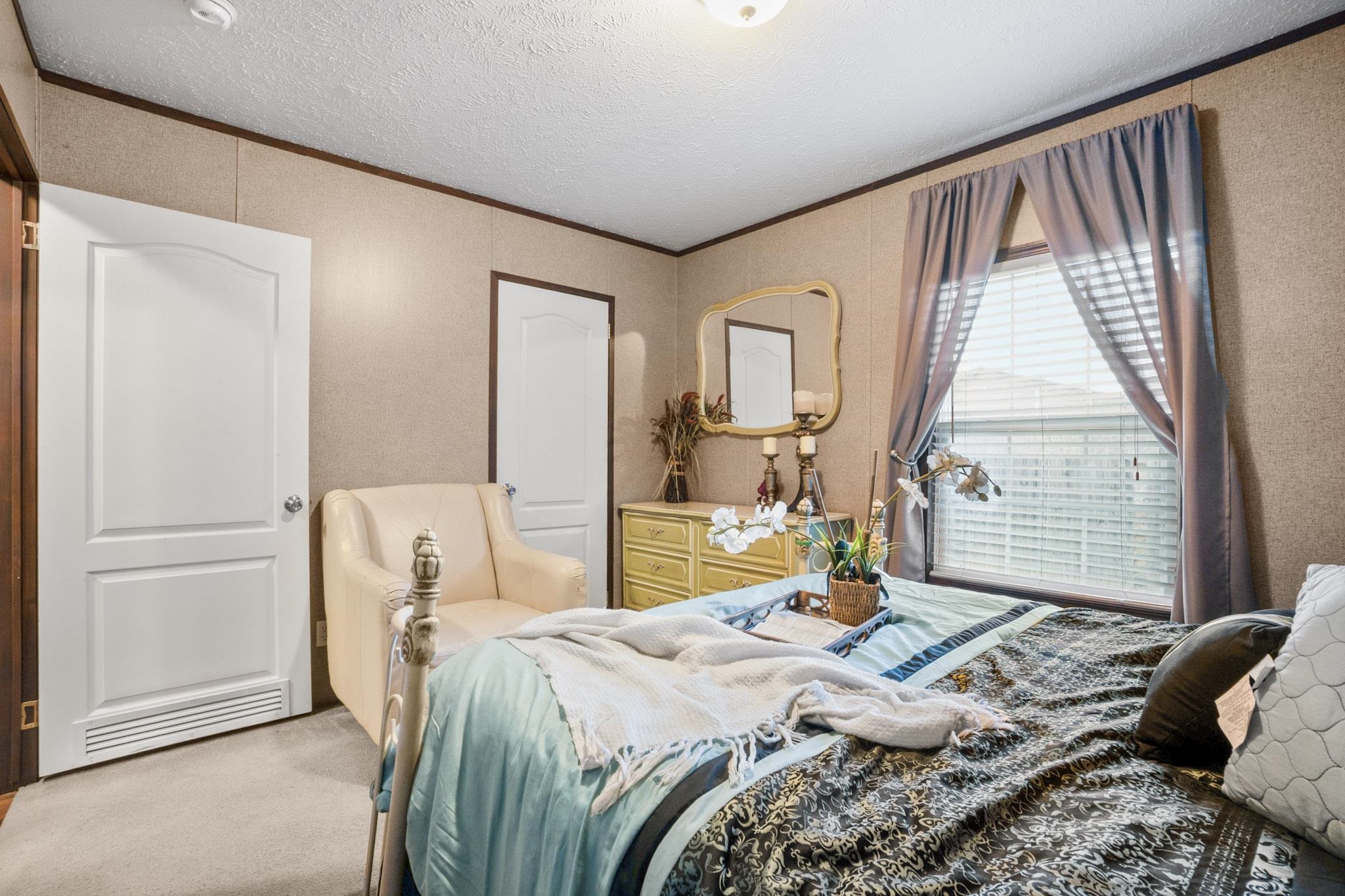 3779 Dancyville Road Stanton, TN 38069 - Photo 19 of 40 a bedroom with a bed a table and chair