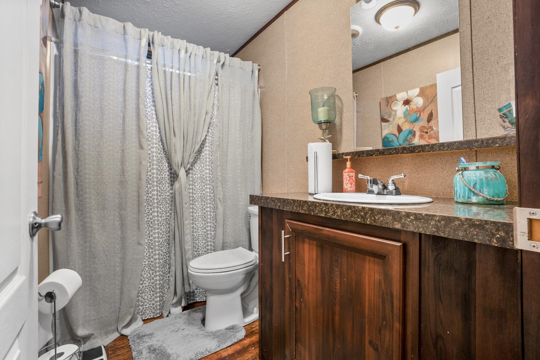 3779 Dancyville Road Stanton, TN 38069 - Photo 20 of 40 a bathroom with a granite countertop sink toilet and shower