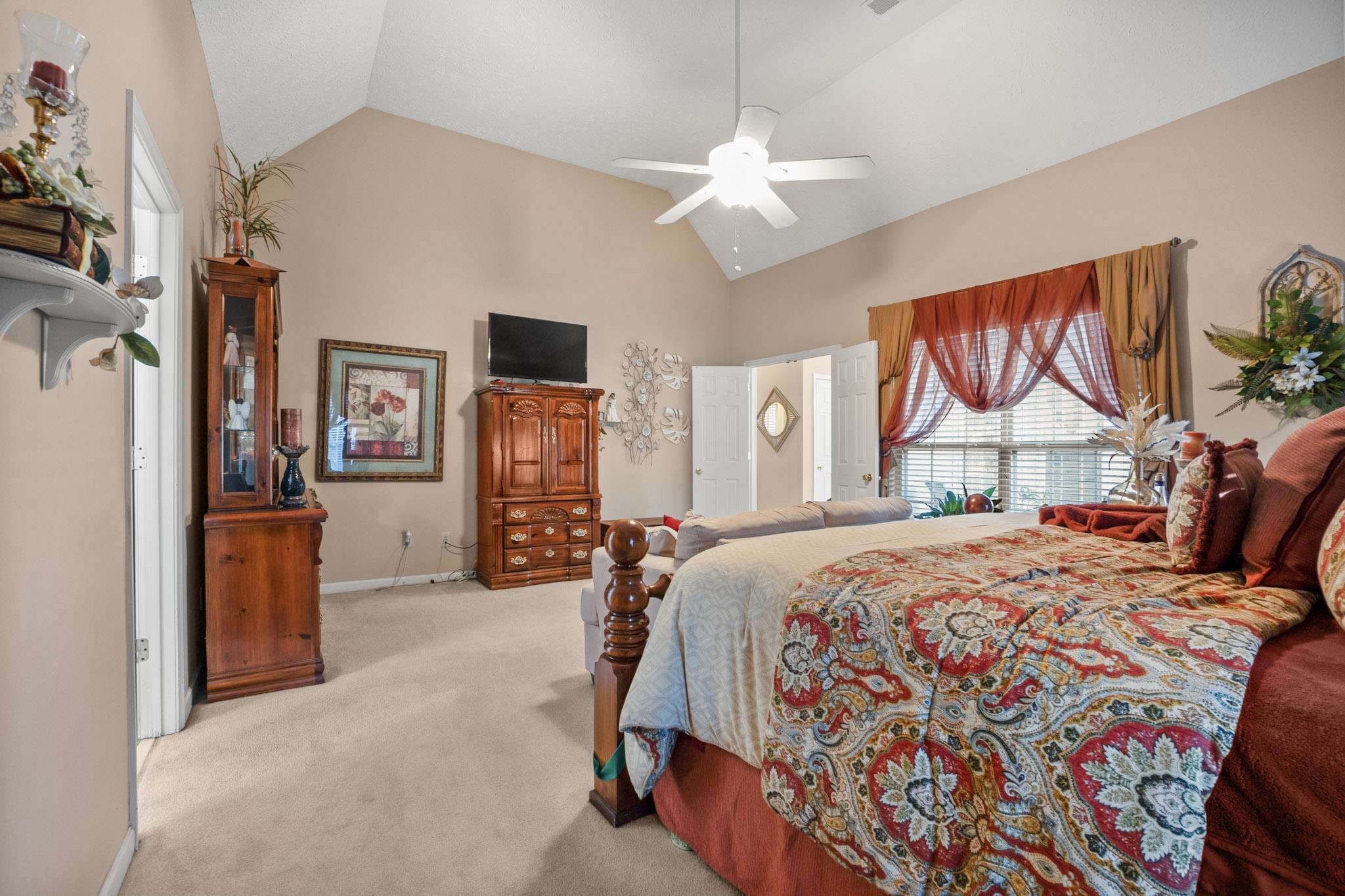 3779 Dancyville Road Stanton, TN 38069 - Photo 28 of 40 a bedroom with a bed and a chandelier