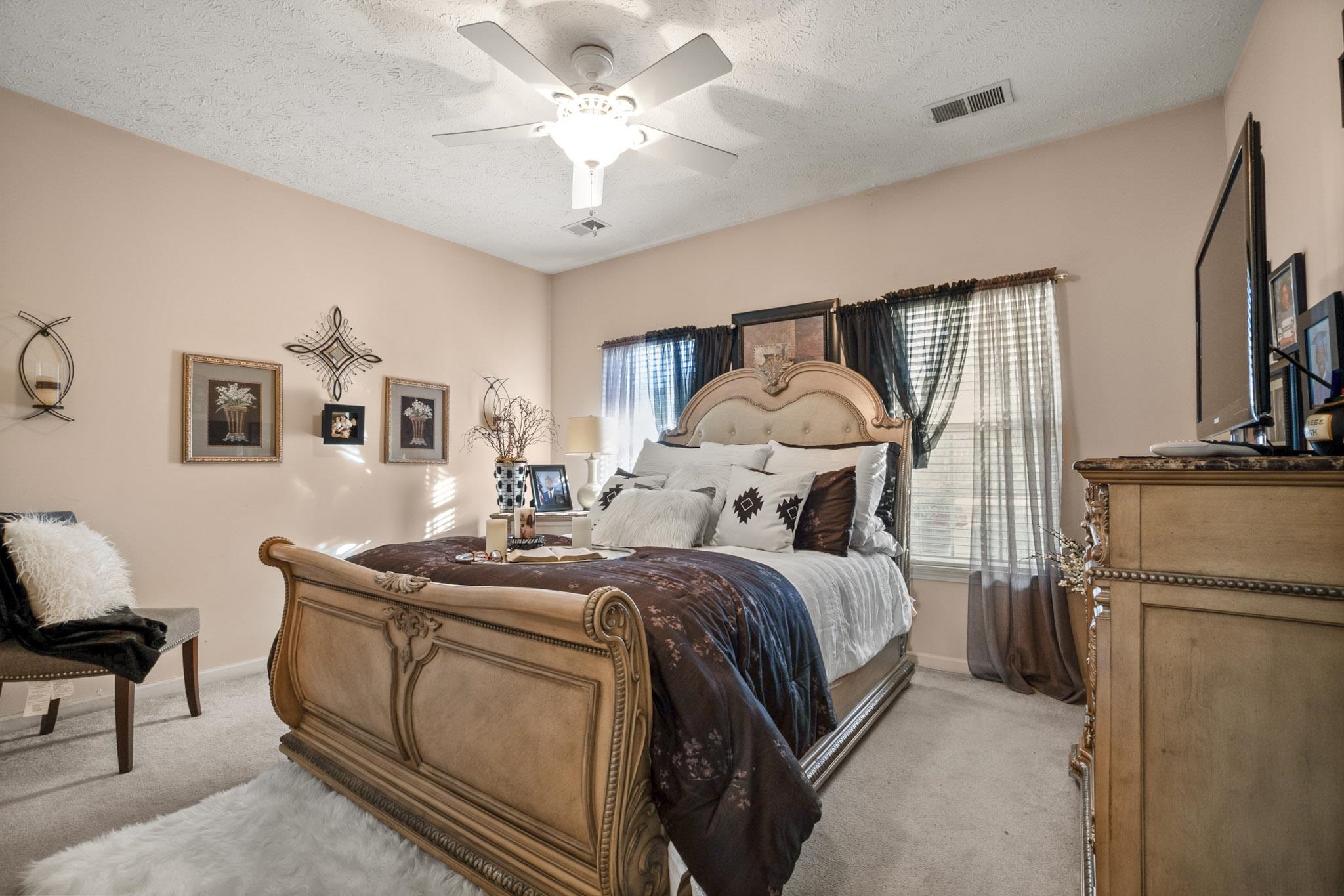 3779 Dancyville Road Stanton, TN 38069 - Photo 30 of 40 a bedroom with bed and a chandelier