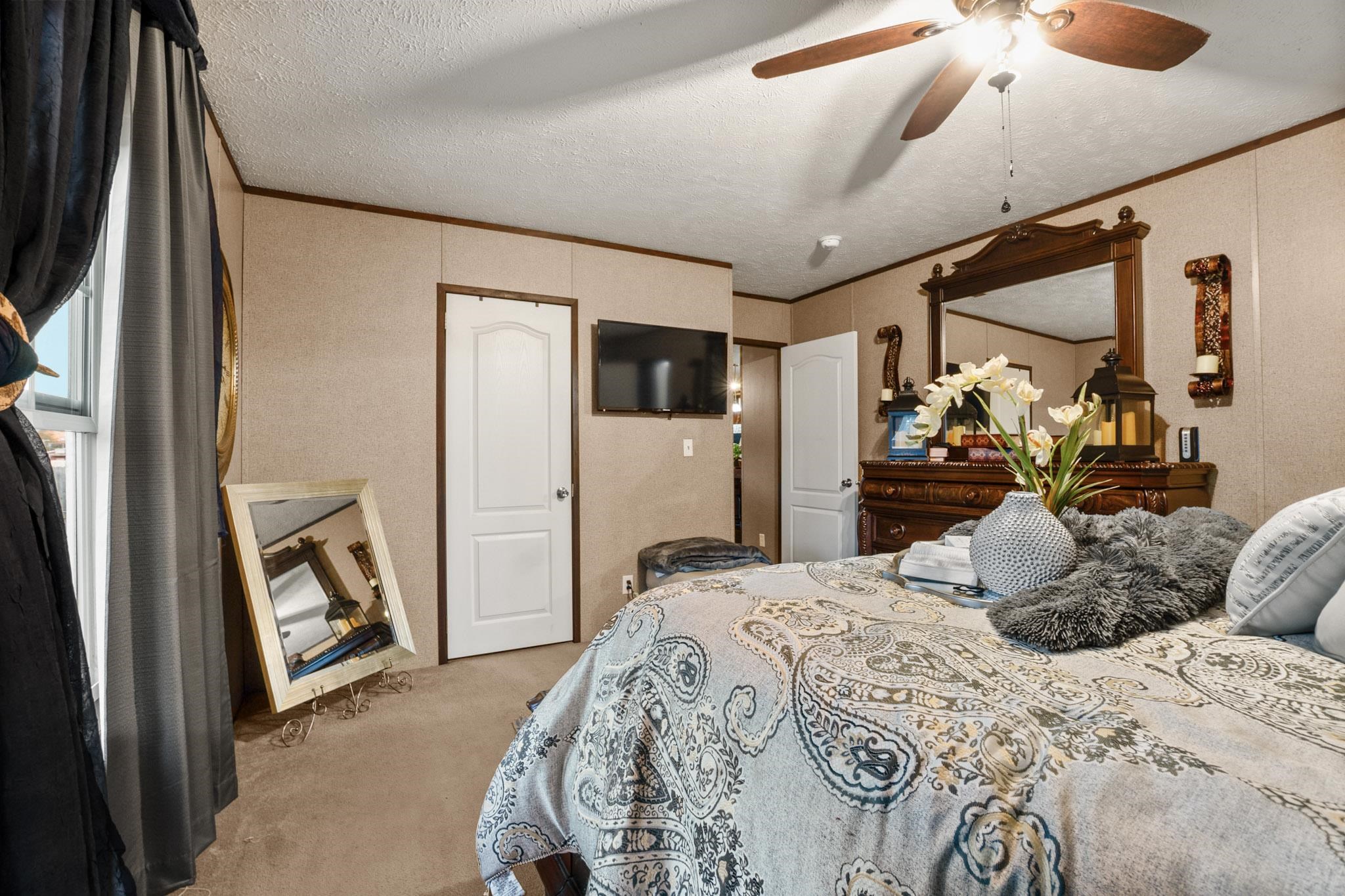 3779 Dancyville Road Stanton, TN 38069 - Photo 31 of 40 a bedroom with a bed and a mirror on the dresser