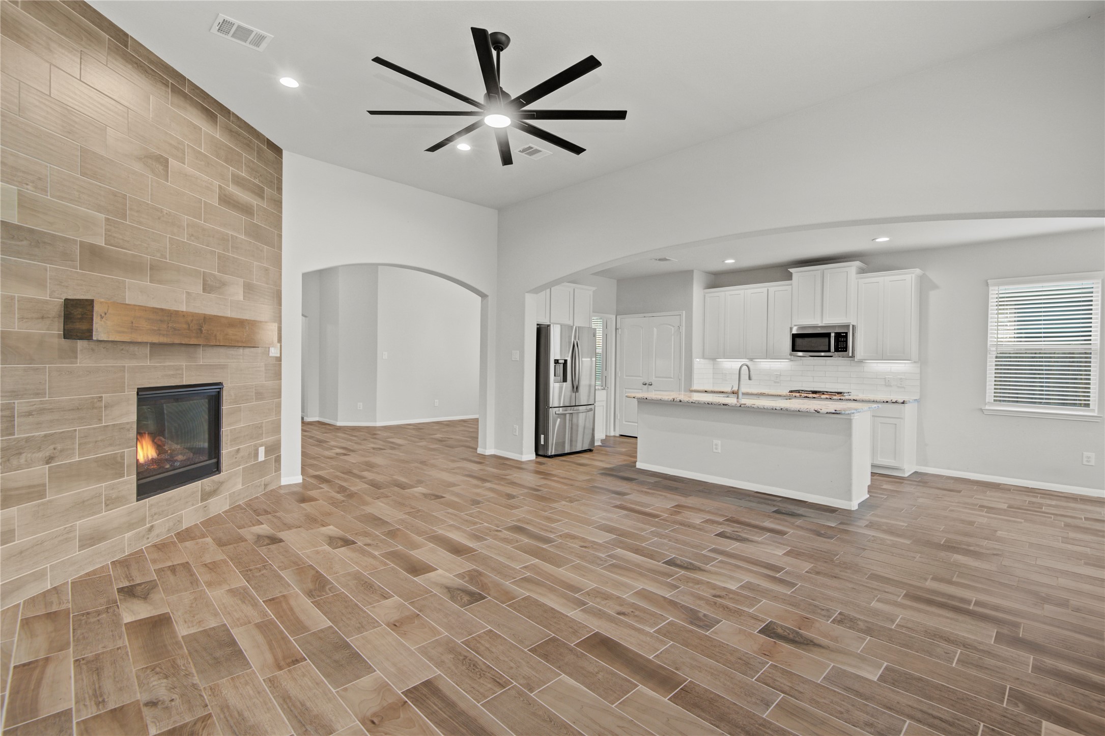 1314 Orchard Ridge Lane Tomball, TX 77375 - Photo 11 of 35 An open-concept design connects the family room seamlessly to the kitchen, ideal for everyday living and entertaining.